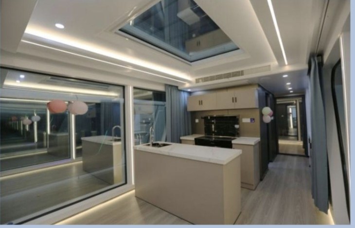 Cabin living area with island bench, ceiling skylight and ambient cove lighting