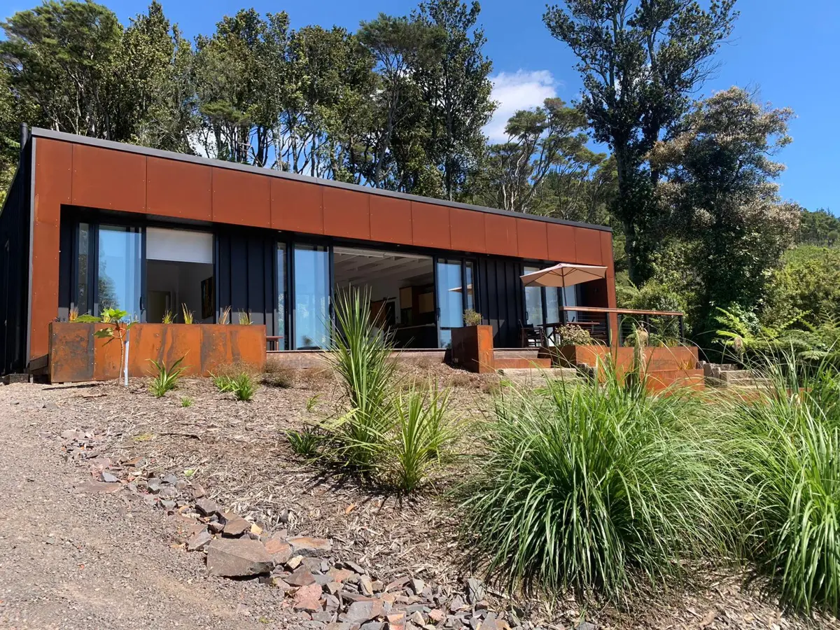 Contemporary residence with corten-clad pavilion and full-height glazing
